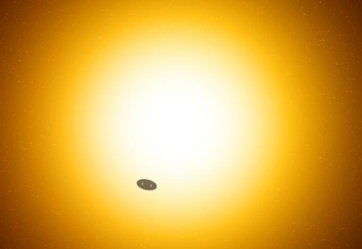 An artist's conception of a ringed planet transiting in front of its host star. (Illustration by Robin Dienel, courtesy of Carnegie Institution for Science)