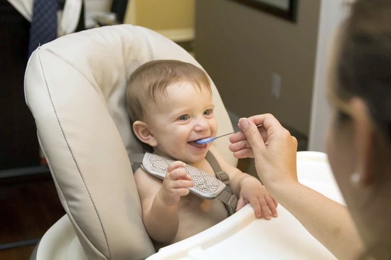 Feeding infants solid food before three months may increase future health risks such as obesity, diabetes, and hypertension.